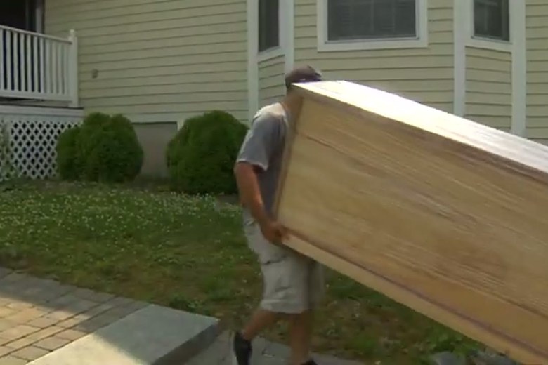 Carrying a wardrobe across the yard