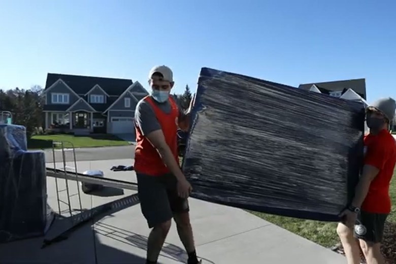 Easing a wrapped dresser down the ramp